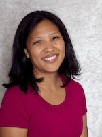 Headshot photo Dr Meda Higa where she is smiling directly at camera while wearing reddish shirt. Her face is framed by shoulder-length straight brown hair.