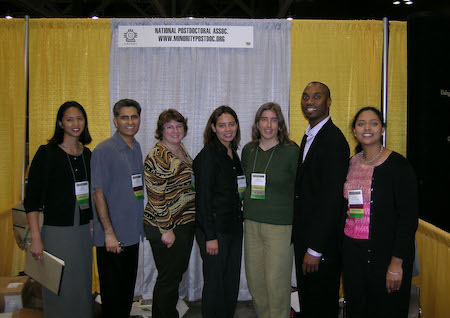 Photo of postdoc booth at 2004 SACNAS annual conference (from left to right) Mia Ong, Alberto Roca, Juana Rudati, Lorena Navarro, Tasha Belfiore, Jabbar Bennett, and Arti Patel.